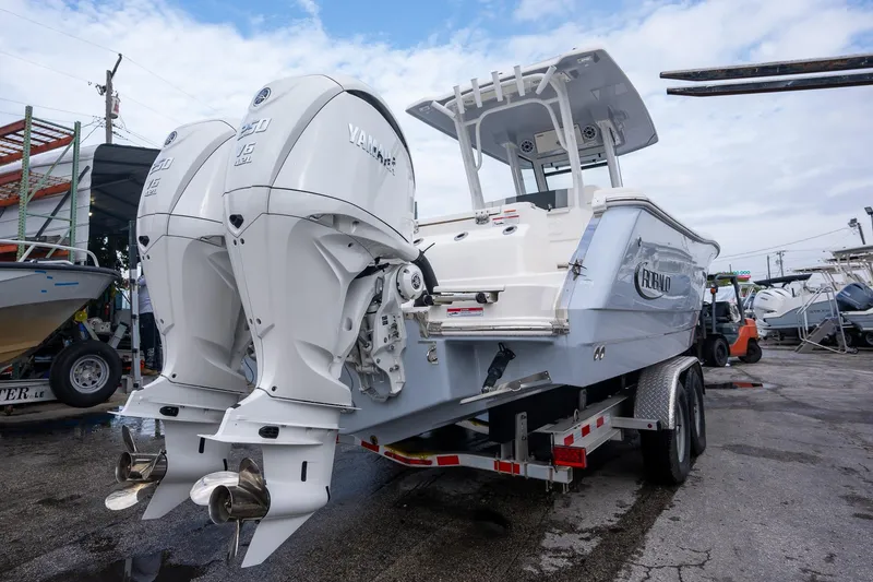 Slide: The Image of 2025 Robalo R270 Center Console boat with dual Yamaha engines on a trailer. - 5