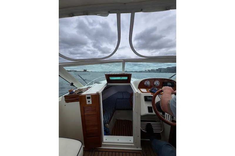 Slide: The Image of Interior view of 2020 Hunt Yachts Harrier 26, showing helm and dashboard controls. - 10