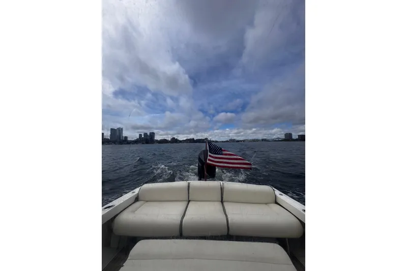 Slide: The Image of 2020 Hunt Yachts Harrier 26 cruising with American flag on open water. - 18