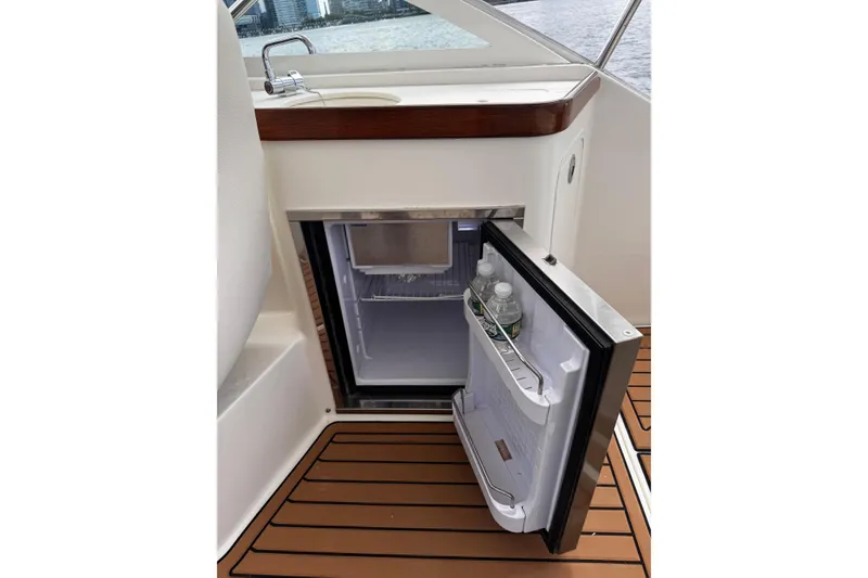 Slide: The Image of Compact refrigerator on 2020 Hunt Yachts Harrier 26, open with water bottles inside. - 22
