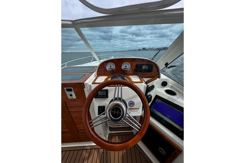 Slide: The Image of 2020 Hunt Yachts Harrier 26 helm with wooden steering wheel and navigation instruments. - 24