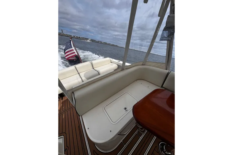 Slide: The Image of 2020 Hunt Yachts Harrier 26 interior with American flag, cruising on open water. - 25