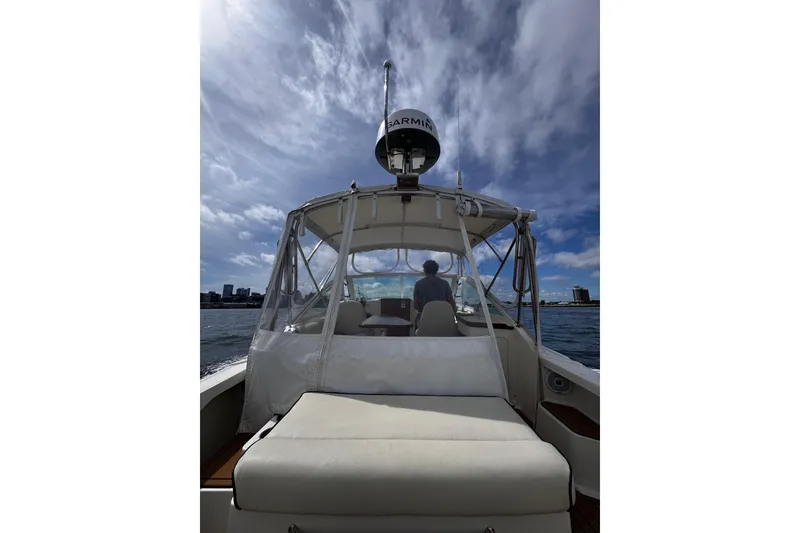 Slide: The Image of 2020 Hunt Yachts Harrier 26 cruising on water under a partly cloudy sky. - 29
