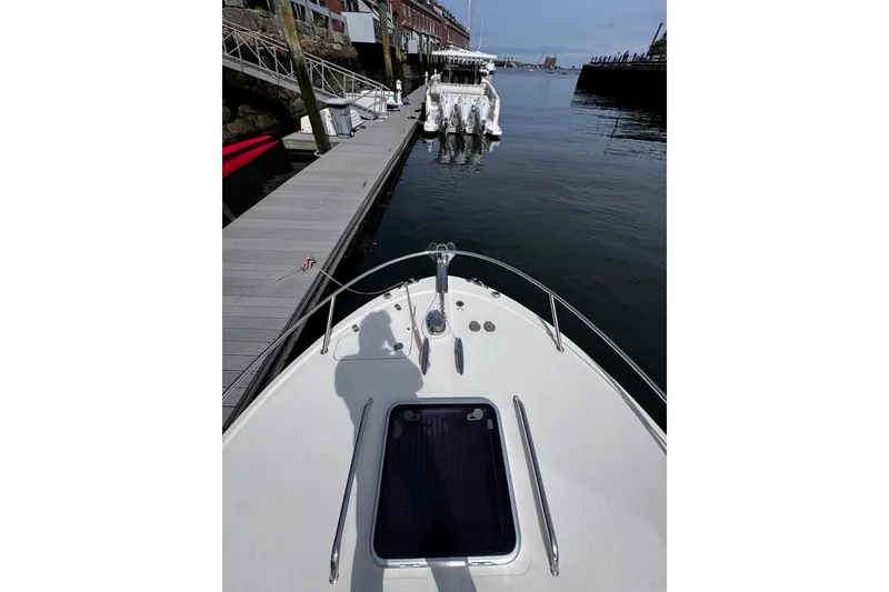 Slide: The Image of 2020 Hunt Yachts Harrier 26 docked at a marina, view from the bow. - 30