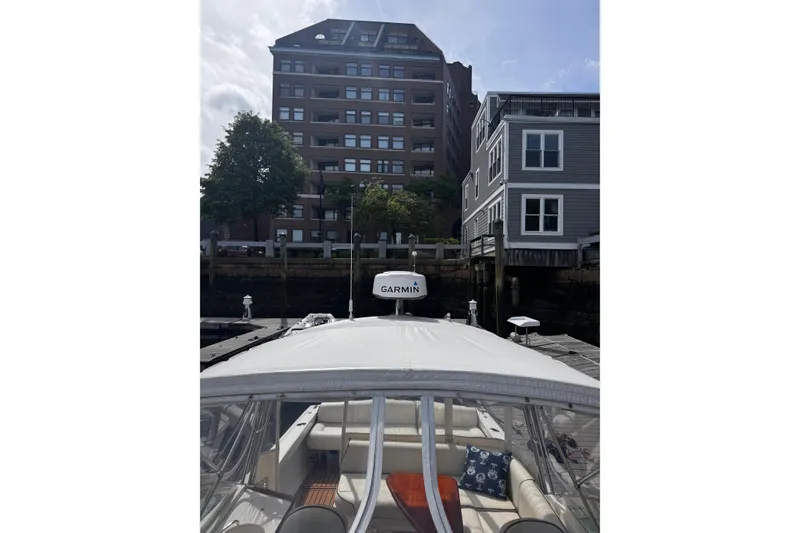 Slide: The Image of 2020 Hunt Yachts Harrier 26 docked near waterfront buildings, featuring Garmin equipment. - 35