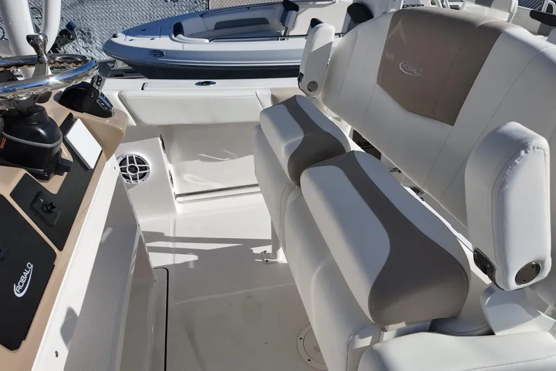 Slide: The Image of 2025 Robalo R232 Explorer boat interior with dual seating and modern dashboard controls. - 6