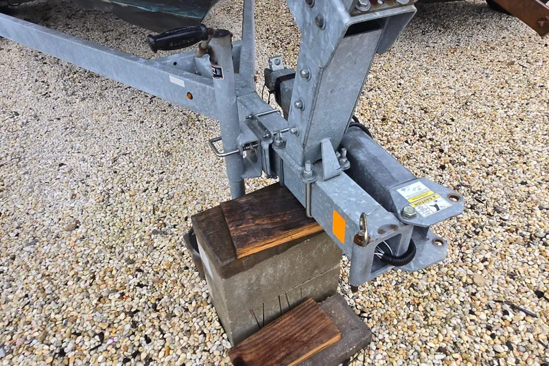 Slide: The Image of Trailer hitch of a 2020 Bayliner VR6 Bowrider OB on gravel surface. - 14