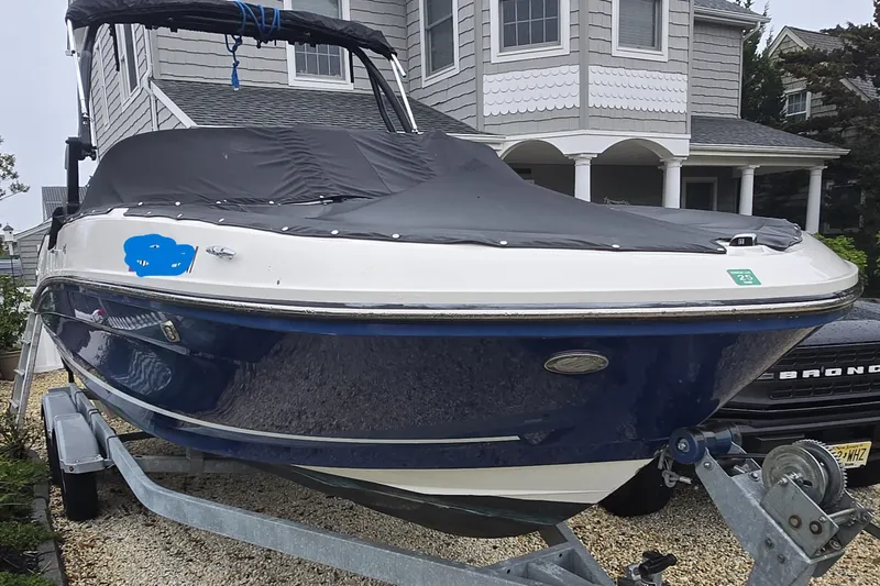 Slide: The Image of 2020 Bayliner VR6 Bowrider OB on trailer, parked in front of a house. - 16