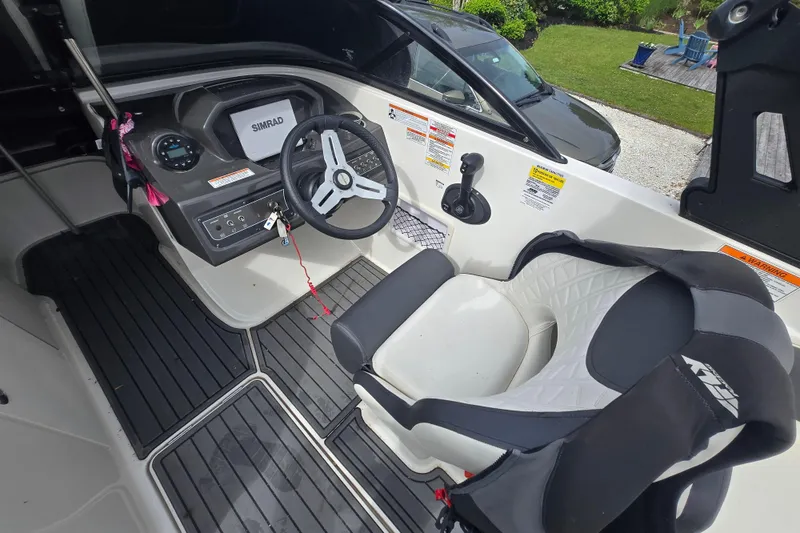 Slide: The Image of 2020 Bayliner VR6 Bowrider OB cockpit with steering wheel and Simrad display. - 19