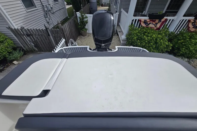 Slide: The Image of 2020 Bayliner VR6 Bowrider OB boat with outboard motor, docked near a house. - 20