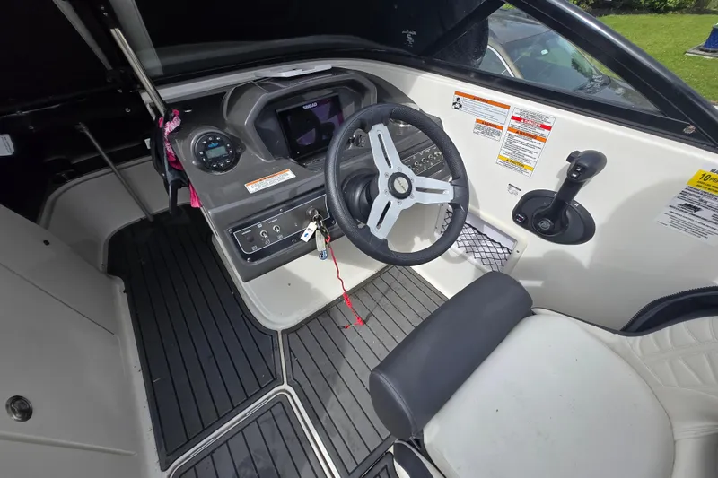 Slide: The Image of 2020 Bayliner VR6 Bowrider OB cockpit with steering wheel and control panel. - 21