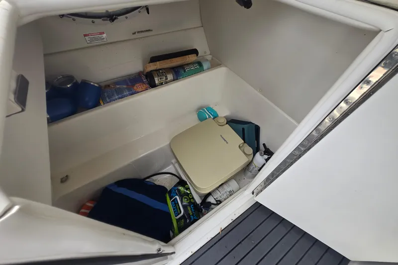 Slide: The Image of Storage compartment in a 2020 Bayliner VR6 Bowrider OB with various boating essentials. - 22