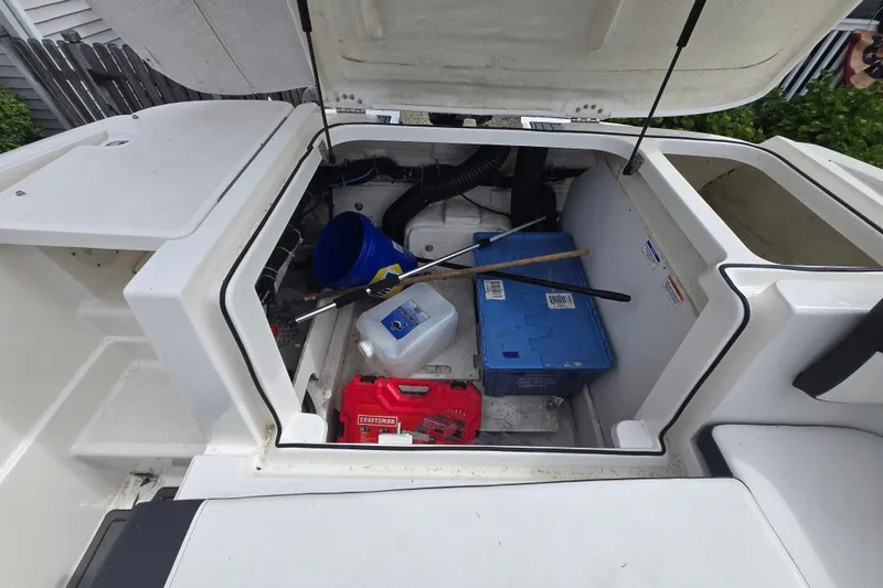 Slide: The Image of Open storage compartment of 2020 Bayliner VR6 Bowrider OB with tools and supplies. - 24