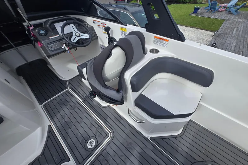 Slide: The Image of 2020 Bayliner VR6 Bowrider OB interior with steering wheel and seating area. - 3