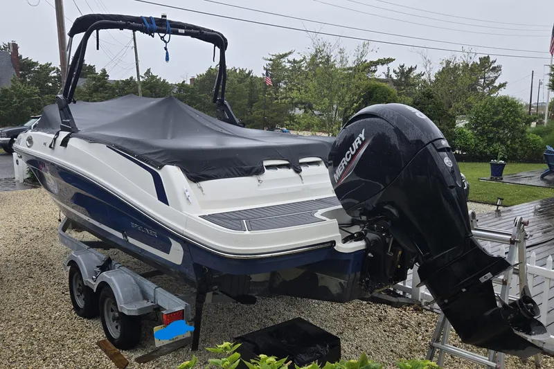 Slide: The Image of 2020 Bayliner VR6 Bowrider OB with Mercury outboard engine on trailer, covered and parked. - 4