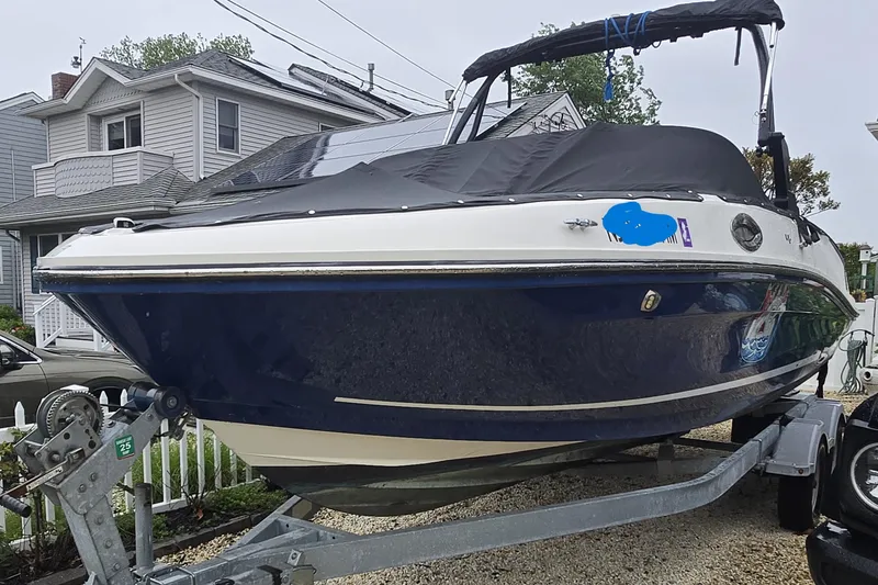 Slide: The Image of 2020 Bayliner VR6 Bowrider OB on trailer, covered, parked in residential area. - 6