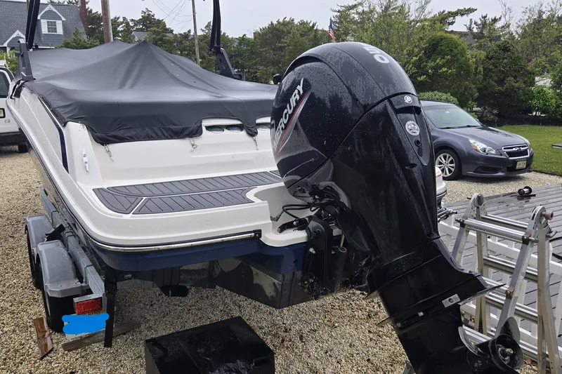 Slide: The Image of 2020 Bayliner VR6 Bowrider OB with Mercury outboard motor on trailer, covered and parked. - 8
