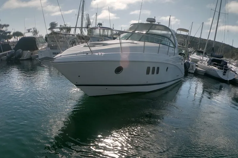Slide: The Image of 2017 Rinker EX 370 yacht docked in a marina under a sunny sky. - 27