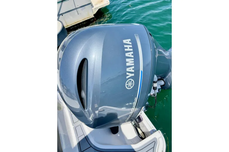 Slide: The Image of Yamaha outboard motor on a 2022 Chaparral 230 SSi boat, docked in clear water. - 10