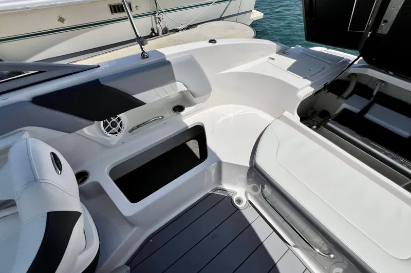 Slide: The Image of Interior view of 2022 Chaparral 230 SSi boat, featuring seating and storage compartments. - 17