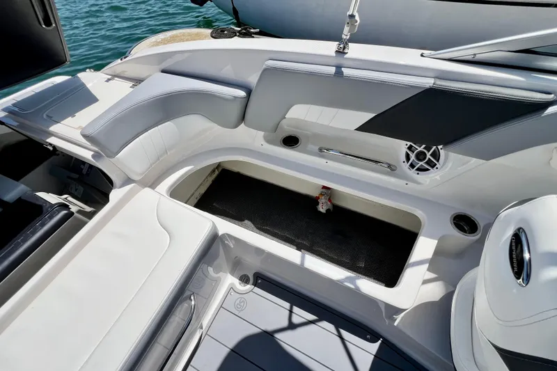 Slide: The Image of 2022 Chaparral 230 SSi boat interior with seating and storage compartment. - 18