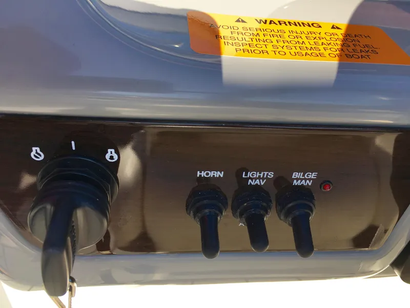 Slide: The Image of Control panel of a 2022 Chaparral 230 SSi with switches for horn, lights, and bilge. - 30