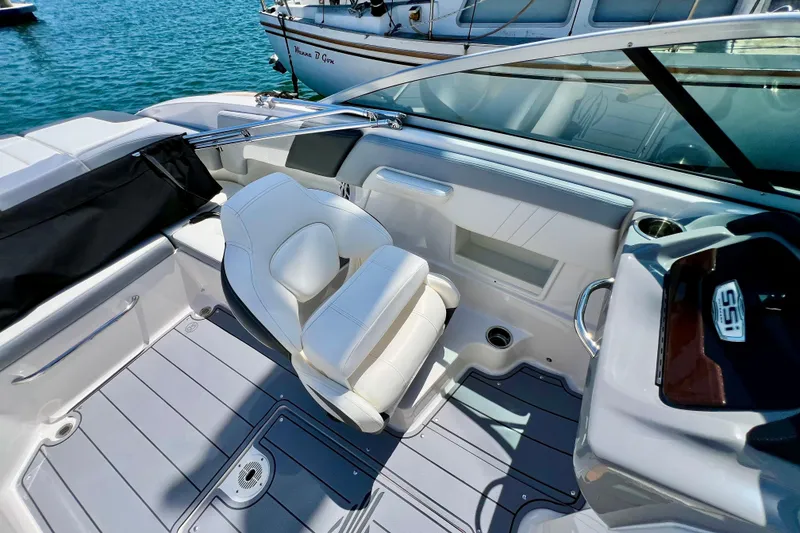 Slide: The Image of 2022 Chaparral 230 SSi boat interior with white seating and sleek design. - 34
