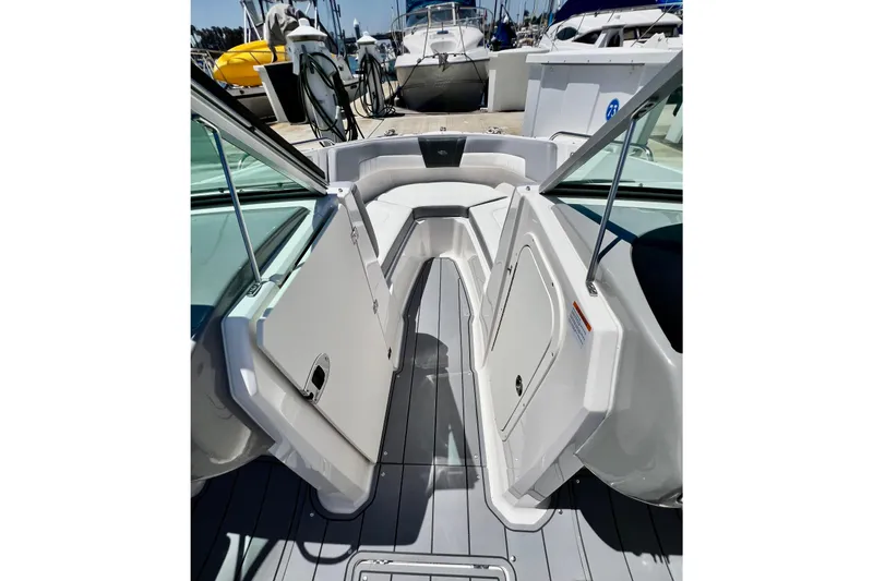 Slide: The Image of 2022 Chaparral 230 SSi boat interior with open bow seating at a marina. - 36