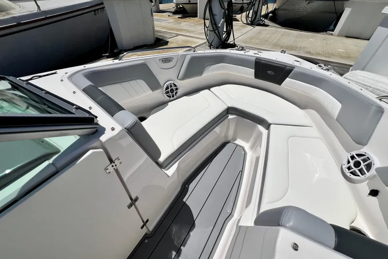 Slide: The Image of 2022 Chaparral 230 SSi boat interior with sleek white seating and modern design. - 41