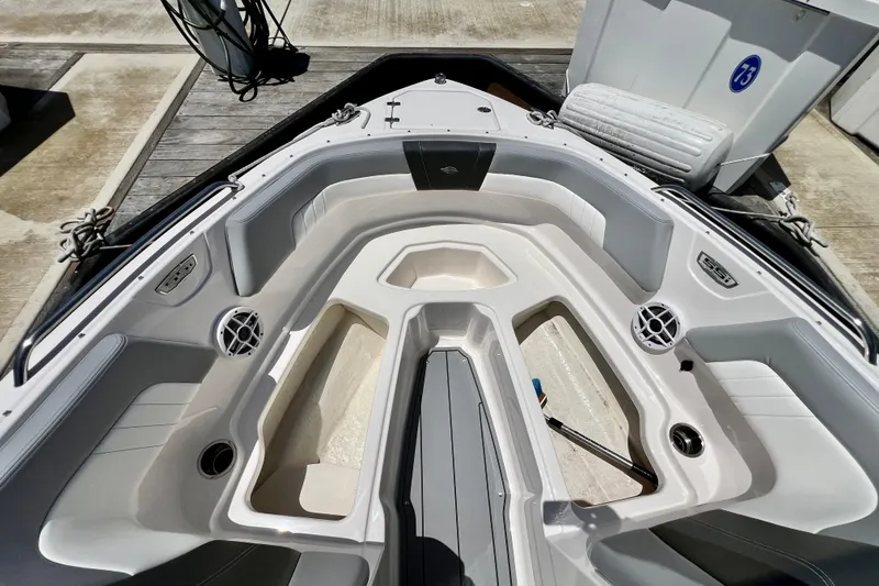 Slide: The Image of 2022 Chaparral 230 SSi boat interior with seating and storage compartments. - 42