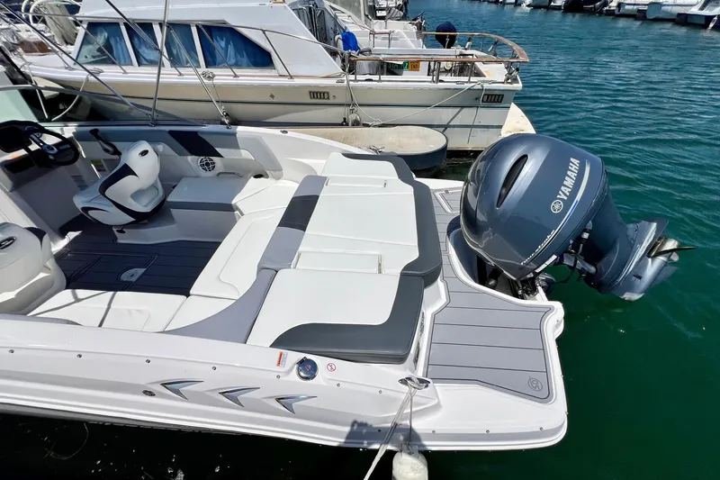 Slide: The Image of 2022 Chaparral 230 SSi boat with Yamaha outboard engine docked at marina. - 9