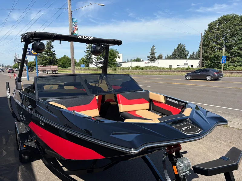 Slide: The Image of 2024 ATX 22 Type-S boat on trailer, black and red, parked on street. - 13