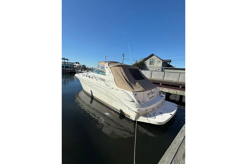 Slide: The Image of 1997 Sea Ray Sundancer 370 docked at marina under clear blue sky. - 11