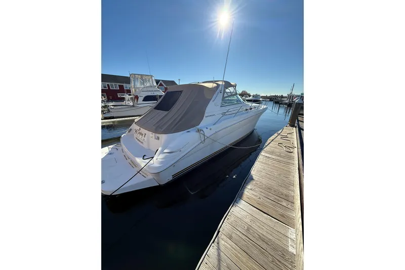 Slide: The Image of 1997 Sea Ray Sundancer 370 docked under clear blue sky. - 12