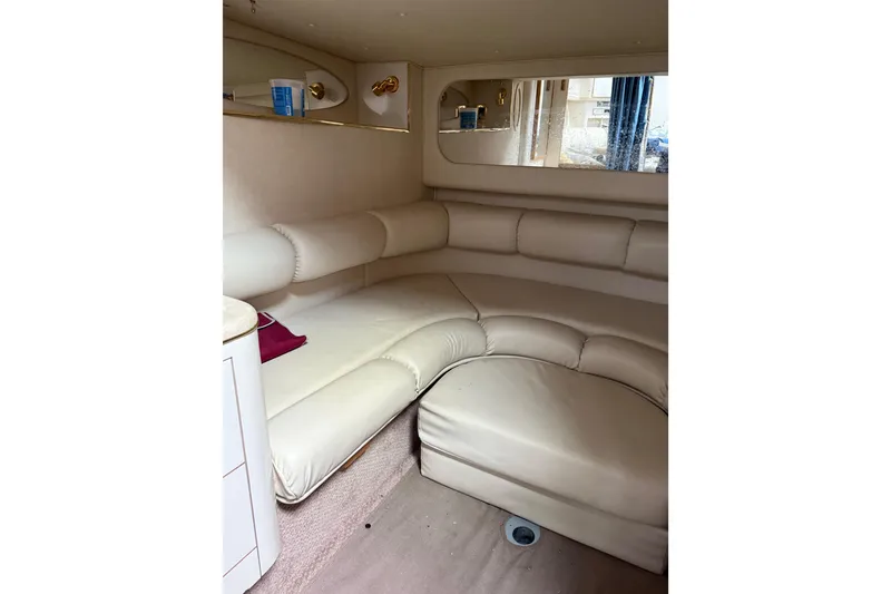 Slide: The Image of Interior of 1997 Sea Ray Sundancer 370 with cream leather seating and mirrored wall. - 16