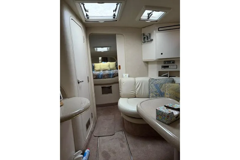 Slide: The Image of Interior of a 1997 Sea Ray Sundancer 370 yacht, featuring cozy seating and elegant decor. - 19