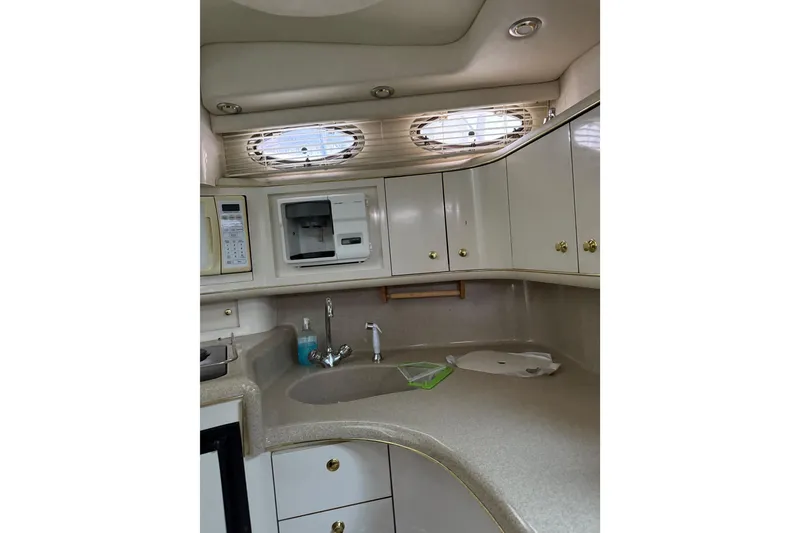 Slide: The Image of Interior of 1997 Sea Ray Sundancer 370 yacht kitchen with cabinets and appliances. - 21