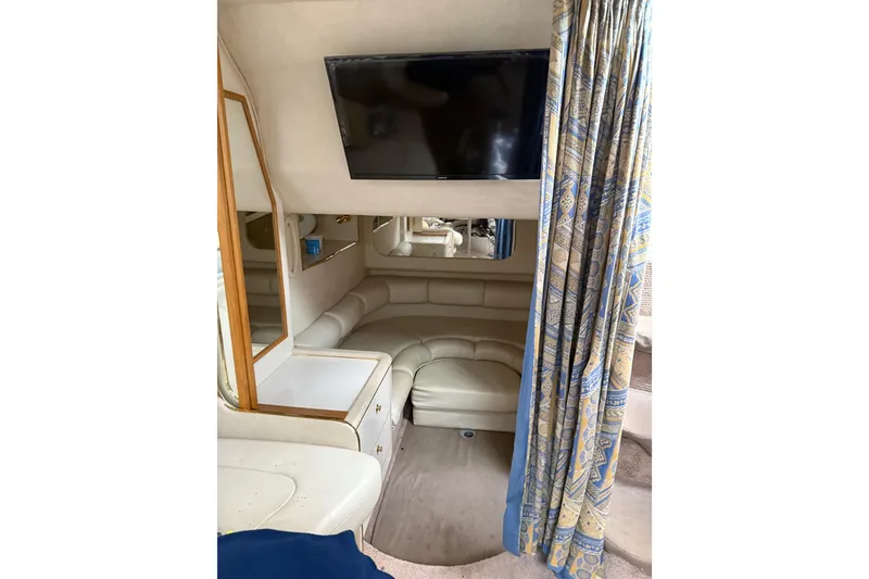 Slide: The Image of Interior of 1997 Sea Ray Sundancer 370 with TV, seating, and patterned curtains. - 23