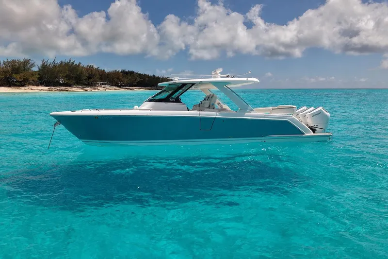 The Image of 2025 Tiara Yachts 38 LS on turquoise water near tropical beach. - 0