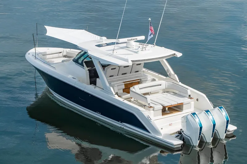 Slide: The Image of Manufacturer Provided Image: 2025 Tiara Yachts 38 LS luxury boat with triple engines on calm water. - 11