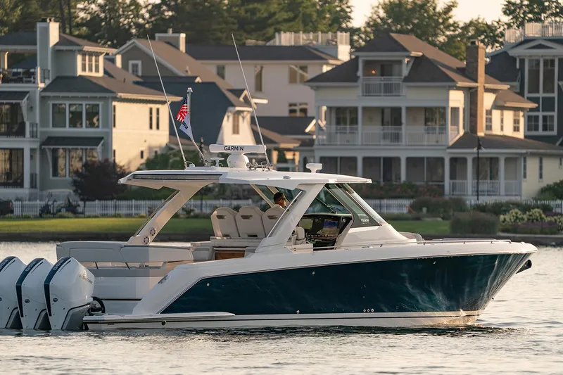 Slide: The Image of Manufacturer Provided Image: 2025 Tiara Yachts 38 LS cruising near waterfront homes. - 13