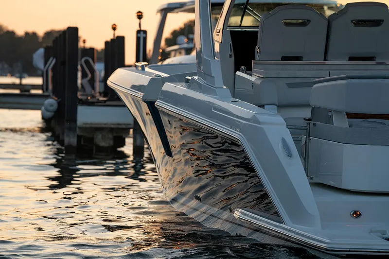 Slide: The Image of Manufacturer Provided Image: 2025 Tiara Yachts 38 LS docked at sunset, reflecting on calm water. - 14