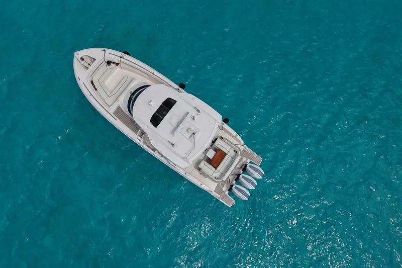 Slide: The Image of Aerial view of 2025 Tiara Yachts 38 LS on clear turquoise water. - 2