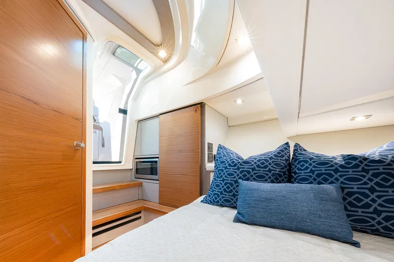 Slide: The Image of Manufacturer Provided Image: 2025 Tiara Yachts 38 LS cabin interior with modern design and blue accent pillows. - 23
