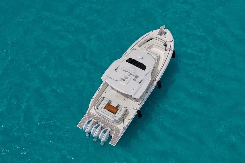 Slide: The Image of Aerial view of 2025 Tiara Yachts 38 LS on clear turquoise water. - 3
