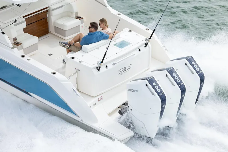 Slide: The Image of Manufacturer Provided Image: 2025 Tiara Yachts 38 LS cruising with triple Mercury engines, featuring luxurious seating. - 5
