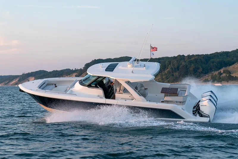 Slide: The Image of Manufacturer Provided Image: 2025 Tiara Yachts 38 LS cruising on open water, showcasing sleek design and powerful engines. - 6
