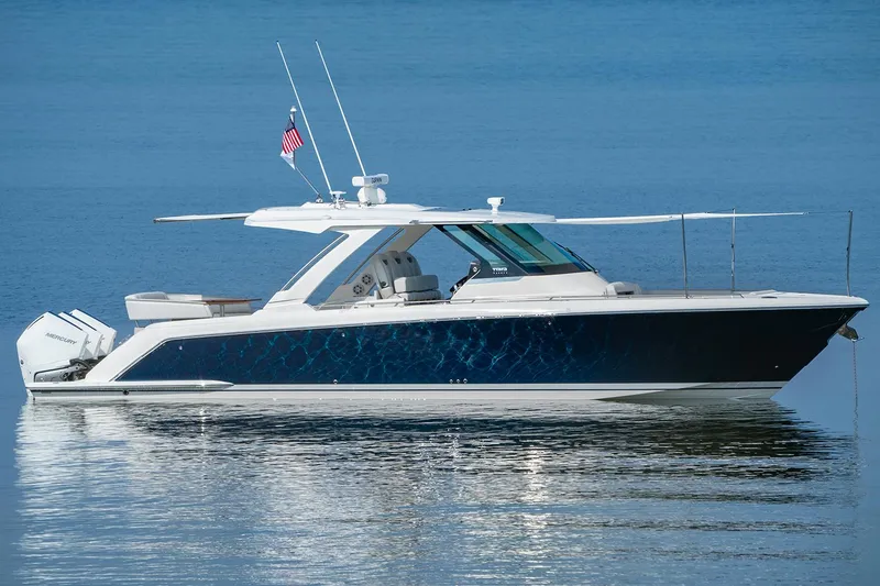 Slide: The Image of Manufacturer Provided Image: 2025 Tiara Yachts 38 LS luxury boat on calm water, side view. - 7