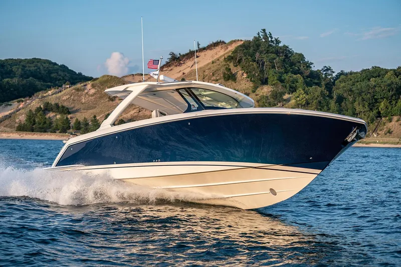 Slide: The Image of Manufacturer Provided Image: 2025 Tiara Yachts 38 LS cruising on water with scenic hillside backdrop. - 9