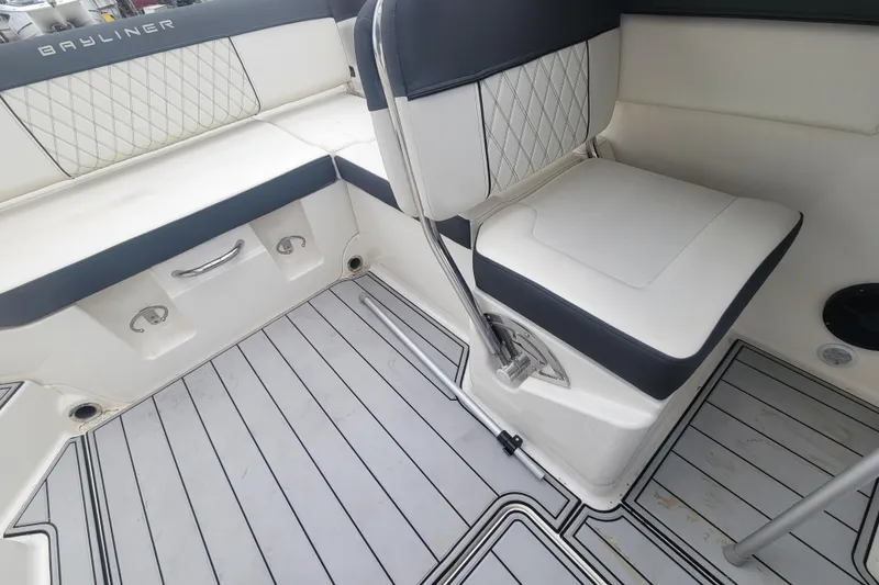 Slide: The Image of 2023 Bayliner DX 2200 boat interior with cushioned seating and sleek flooring. - 10